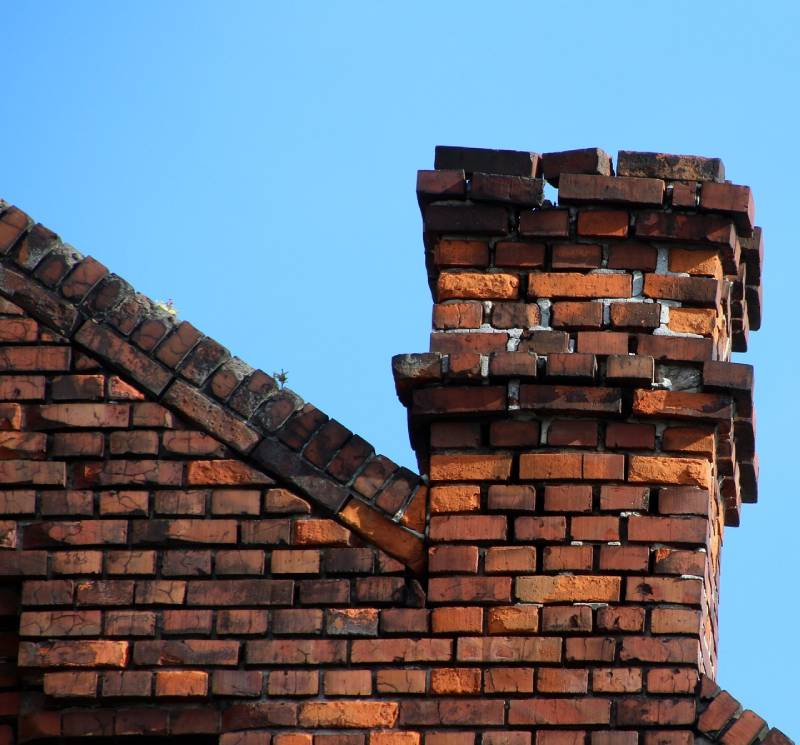 Damaged chimney on an Norwell home showing cracks and missing mortar